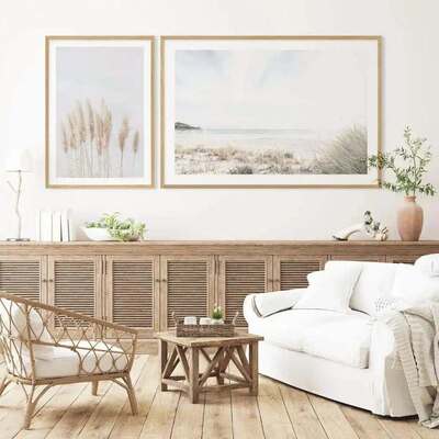 Elegant coastal living room with a cream sofa, natural stone coffee table, and linen curtains.